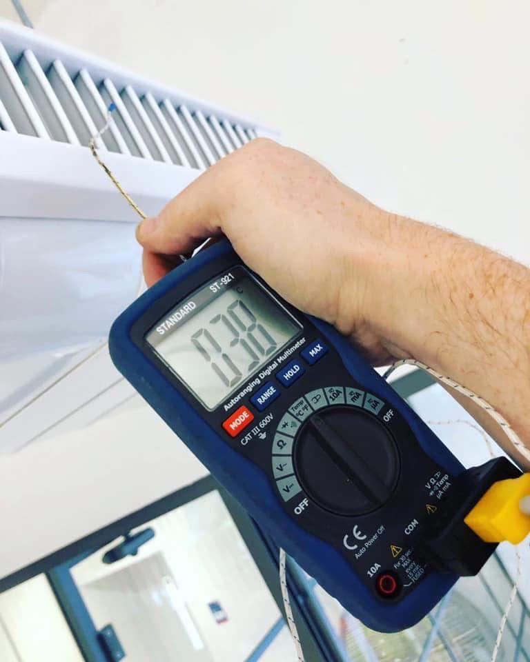 Engineer testing AC system