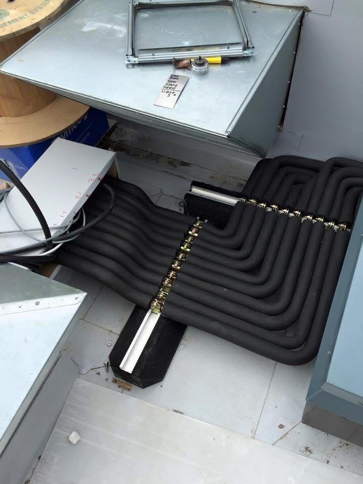 Heat pump pipework manifold in plant room — Air Logic heating installation